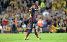 Barcelona's Brazilian forward Neymar da Silva Santos Junior applauds as he leaves the pitch during the Spanish league Clasico football match FC Barcelona vs Real Madrid CF at the Camp Nou stadium in Barcelona on 26 October 2013. Picture: AFP/LLUIS GENE