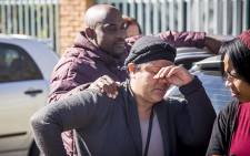 An emotional Colleen Duister wipes a tear from her face while her partner puts his hand on her shoulder outside the Germiston pathology laboratory where they have waited for a week for the body of their three-year-old child due to the forensic workers' strike. Picture: Reinart Toerien/EWN