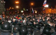 Pro-Russian protesters, some holding Russian national flags, storm regional administration buildings in the eastern Ukrainian city of Kharkiv on 6 April, 2014. Picture: AFP.