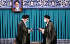 A handout picture provided by the office of Iran's Supreme Leader Ayatollah Ali Khamenei on 3 August 2021, shows him (L) during the inauguration ceremony for Ebrahim Raisi (R) as President, in Khamenei's office in the capital Tehran. Ultraconservative Raisi was inaugurated as president of Iran, a country whose hopes of shaking off a dire economic crisis hinges on reviving a nuclear deal with world powers. Picture: AFP