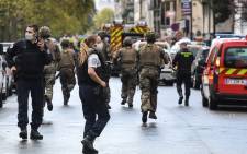 French army soldiers rush to the scene after several people were injured near the former offices of the French satirical magazine ‘Charlie Hebdo’ following an alleged attack by a man wielding a knife in the capital Paris on 25 September 2020. Picture: AFP. 