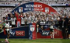 Fulham's players celebrate with the trophy on the pitch after the English Championship play-off final football match between Aston Villa and Fulham at Wembley Stadium in London on May 26, 2018. Fulham won the game 1-0, and are promoted to the Premier League. Picture: AFP.