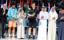 World number one Andy Murray (C) of Great Britain and Spain's Fernando Verdasco celebrate with their respective first and second-place trophies after the conclusion of their ATP final tennis match during the Dubai Duty Free Championships. Picture: AFP.