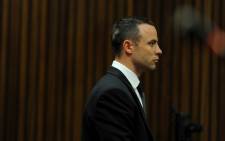 Oscar Pistorius stands in the dock at the High Court in Pretoria as Judge Thokozile Masipa rules on an application to have him referred for mental observation, 14 May 2014. Picture: Pool.
