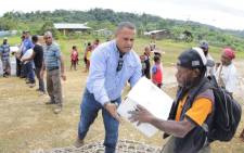 An undated handout photo received on 5 March from Oil Search Limited shows Oil Search staff helping locals distribute supplies from Oil Search and the Australian government in Papua New Guinea. Picture: AFP