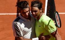 Spain's Rafael Nadal (R) hugs Switzerland's Roger Federer (L) after winning their men's singles semi-final match on day 13 of The Roland Garros 2019 French Open tennis tournament in Paris on 7 June 2019. Picture: AFP