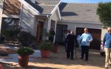 Archbishop Emeritus Desmond Tutu, dressed in black, is accompanied by IEC officials outside his house in Milnerton where he voted on 6 May 2019. Picture: Shamiela Fisher/EWN