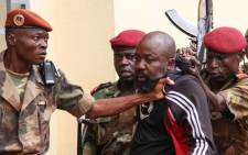 In this file photo taken on 29 October 2018, members of the armed forces arrest Central African MP Alfred Yekatom aka "Rambo" (C), who represents the southern M'baiki district former militia leader, after he fired the gun at the parliament in Bangui. Picture: AFP.