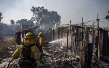 Firefighters battle the Tick Fire in houses on fire in Brentwood, California on 28 October 2019. Picture: AFP