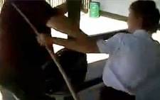 A screengrab from a cellphone video showing a Grade 8 Glenvista High School pupil assaulting a teacher with a broom.