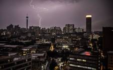 A lightning bolt crosses the Johannesburg skyline during a storm in November 2020. Picture: AFP.