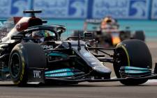 Mercedes driver Lewis Hamilton drives ahead of Red Bull driver Max Verstappen at the Yas Marina Circuit during the Abu Dhabi Formula One Grand Prix on 12 December 2021. Picture: Giuseppe CACACE/AFP