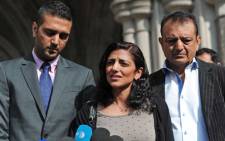 Anni Dewani's sister Ami Denborg (C) flanked by brother Anish Hindocha (L) and father Vinod Hindocha (R) outside the High Court in central London. Picture: AFP.