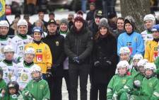 Britain’s Prince William and his wife Kate pose together with youth from the Hammarby bandy sports club in Stockholm. Picture: @KensingtonRoyal/Twitter.