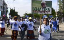 Senegal's opposition demonstrators hold pictures of the Mayor of Dakar Khalifa Sall and of former minister Karim Wade during a march to demand transparency in the 2019 elections, in Dakar, on 28 December 2018. Picture: AFP