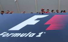 FILE: Fans looks over the circuit above a board reading Formula 1 during the second practice session at the Formula One Japanese Grand Prix in Suzuka. Picture: AFP