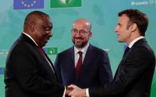 South Africa's president Matamela Cyril Ramaphosa (L) is welcomed by President of the European Council Charles Michel (C) and France's President Emmanuel Macron (R) during the first day of the sixth European Union (EU) African Union (AU) summit at The European Council Building in Brussels on February 17, 2022. Picture: AFP.