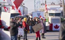Protestors against COVID-19 vaccine mandates block the roadway at the Ambassador Bridge border crossing in Windsor, Ontario, Canada, on 9 February 2022. Picture: Geoff Robins/AFP