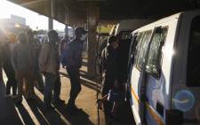 Commuters board a minibus taxi at the Baragwanath taxi rank in Soweto, Johannesburg. 