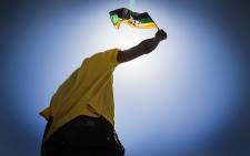 An ANC supporter waves his party's colours at the 104 years celebration in Grabouw. Picture: Thomas Holder/EWN