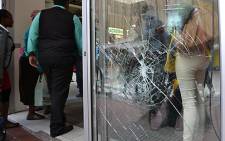 Damage to an Adderley Street shop front after protesters demonstrated in in the Cape Town CBD on 30 October 2013. Picture: Aletta Gardner/EWN.
