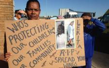 FILE: A community member holds a poster of slain Lekita Moore outside the Bishop Lavis Magistrates Court on Wednesday 14 September 2016. Picture: Lauren Isaacs/EWN.