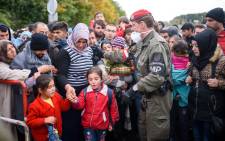 Migrants and refugees cross the Slovenian-Austrian border in Sentilj onto Spielfeld on 20 October, 2015. Picture: AFP.