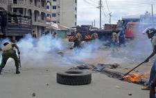 Kenyan police fire tear gas during riots sparked by the killing of a Muslim cleric in the port city of Mombasa on 4 October 2013. Picture: AFP