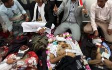 Yemeni men and medica prepare the bodies of protesters who were killed during an anti-government demonstration in Sanaa March 18, 2011. Picture: AFP 