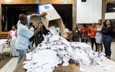 An Independent Electoral Officer (IEC) opens a ballot box as counting begins at the Addington Primary School after voting ended at the sixth national general elections in Durban, on 8 May 2019. Picture: AFP