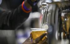 FILE: A bartender pours a draught beer. Picture: EWN.