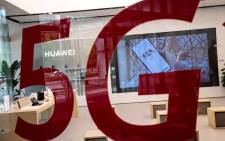 FILE: A shop for Chinese telecom giant Huawei features a red sticker reading '5G' in Beijing on in May 2020. Picture: AFP.