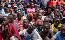 Survivors listen to Zimbabwe's President Emmerson Mnangagwa (unseen) adressing residents of Ngangu, a township of Chimanimani during his tour of the affected areas, following a devastation by cyclone Idai on 20 March 2019. Picture: AFP