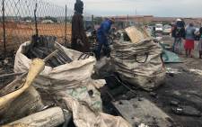 Waste pickers are taking the scrap metal from the fire in Alexandra. Picture: Mia Lindeque/EWN