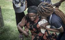 Antionette Mpianzi becomes emotional as she nears the river where her son Enock Mpianzi drowned during a visit to the Nyati Bush and River Break resort on 21 January 2020. Picture: Abigail Javier/EWN