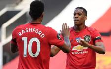 FILE: Manchester United's striker Anthony Martial (R) celebrates scoring the opening goal with teammate Marcus Rashford during the English Premier League football match between Manchester United and Sheffield United at Old Trafford in Manchester, north west England, on 24 June 2020. Picture: AFP