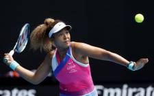 FILE: Japan's Naomi Osaka hits a return against Colombia's Camila Osorio during their women's singles match on day one of the Australian Open tennis tournament in Melbourne on 17 January 2022. Picture: Brandon Malone/AFP