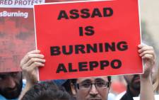 A protester holds a banner as he takes part in a demonstration in front of United Nations offices in Beirut in solidarity with the civilians of the northern Syrian city of Aleppo and against the regime of the Syrian president, on 1 May, 2016. Picture: AFP.