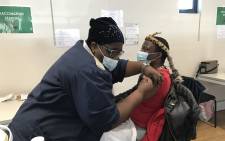 Gqola - a traditional healer - gets vaccinated against Covid-19. Picture: Kevin Brandt/ Eyewitness News. 