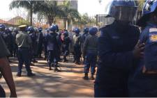There is a standoff between police and Movement for Democratic Change (MDC) Alliance supporters outside the gates of the electoral commission's results centre in Harare. Picture: Masechaba Sefularo/EWN