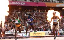 US athlete Tori Bowie (C) crosses the finish line next to Ivory Coast's Murielle Ahoure (L) and Jamaica's Elaine Thompson to win the final of the women's 100m athletics event at the 2017 IAAF World Championships at the London Stadium in London on August 6, 2017.  (Picture: AFP