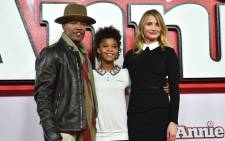US actors Jamie Foxx (L), Quvenzhane Wallis (C) and Cameron Diaz (R) pose for pictures during a photocall for the film 'Annie' in central London on 16 December, 2014. Picture: AFP.