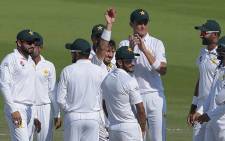 Pakistani spinner Yasir Shah (C) holds the ball as he celebrates with teammates after breaking fastest 200 wickets record during the fourth day of the third and final Test cricket match between Pakistan and New Zealand at the Sheikh Zayed International Cricket Stadium in Abu Dhabi on 6 December, 2018. Picture: AFP