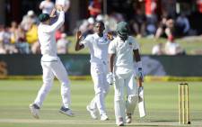 Proteas bowler Kagiso Rabada (C) celebrates the dismissal of Zimbabwean batsman Chamu Chibhabha (R) during the day two of the day-night Test match between South Africa and Zimbabwe at St George's Park in Port Elizabeth on 27 December, 2017. Picture: AFP