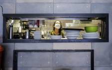 A worker prepares a restaurant to reopen for food deliveries in Melville, Johannesburg, on 1 May 2020, in accordance with the Stage 4 lockdown regulations. Picture: AFP
