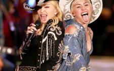 Miley Cyrus with Madonna perform onstage during 'Miley Cyrus: MTV Unplugged'. Picture: MTV.