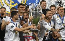 Real Madrid's Croatian midfielder Luka Modric lifts the trophy as Real Madrid players celebrate winning the UEFA Champions League final football match between Liverpool and Real Madrid at the Olympic Stadium in Kiev, Ukraine on May 26, 2018. Picture: AFP.