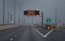 A road sign warns travellers of the approaching Hurricane Harvey on 25 August 2017 in Corpus Christi, Texas. Hurricane Harvey has intensified into a hurricane and is aiming for the Texas coast with the potential for up to 3 feet of rain and 125 mph winds. Picture: AFP.