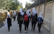 In this picture taken on 9 August 2022, Afghan primary schoolgirls walk to their school along a street in Kabul. Picture: Wakil KOHSAR/AFP