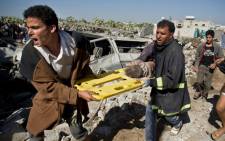 FILE: A screebgran picture shows people carrying an injured child in Yemen after Saudi-led air strikes in an ongoing war between the two countries.  